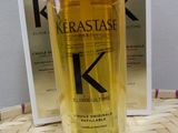 two bottles of kerastase hair oil sitting on top of a table