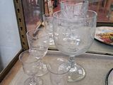 several empty wine glasses are sitting on a table in front of a glass case