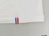 a white shirt with a red, white, and blue stripe on it