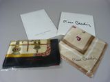 three pieces of cloth are sitting on a table next to a card
