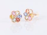 a close up of a pair of earrings on a white surface