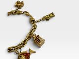 a close up of a gold bracelet with charms on it