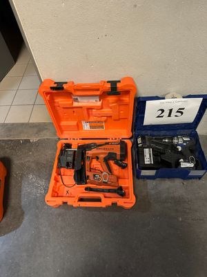 an orange tool box with a hammer, drill, and other tools in it