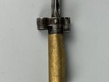 a close up of a metal object with a gold colored handle