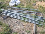a pile of metal rods sitting on the ground in the grass
