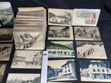 a lot of old postcards that are on a table