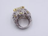 a close up of a ring with a yellow stone on top of it