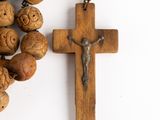 wooden rosary with a crucif on a white background