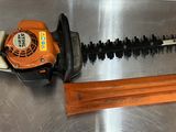 an image of a chainsaw and a tool on a metal surface