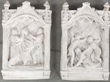 two white statues of jesus and mary on a gray background
