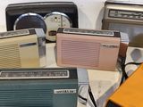 many different types of radio sitting on a table