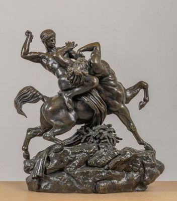 bronze statue of a man riding a horse with a woman on it