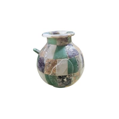 a vase that is sitting on a white surface