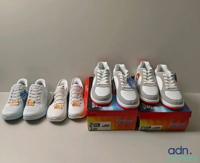 several pairs of shoes are lined up in a row on a table