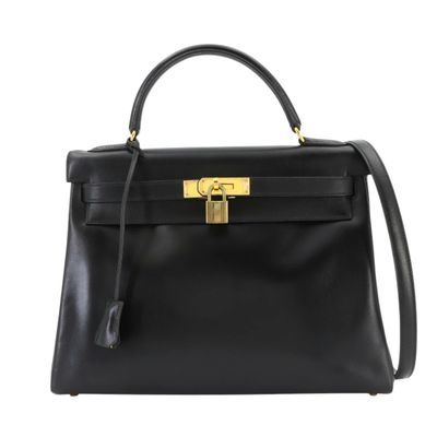 a black leather handbag with a gold lock on the handle