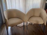 two chairs sitting next to each other on a hard wood floor