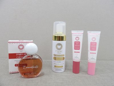 a bottle of perfume next to a box of creams and a tube of lotion