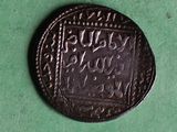 a close up of a coin on a green surface
