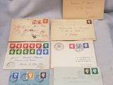 four envelopes with stamps and stamps on them sitting on a table