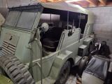 a military vehicle that is parked in a garage