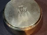 a silver box with a monogram on it