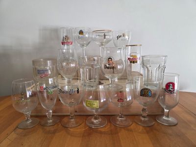 many wine glasses sitting on a wooden table