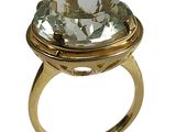 an image of a gold ring with a green topazt stone