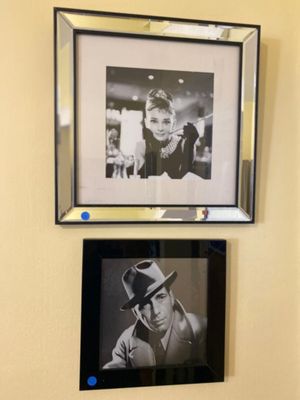 two pictures hanging on the wall above a toilet