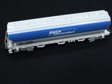 a blue and white train car sitting on a black surface