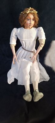 a doll that is sitting on a black surface