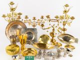 a lot of gold and silver items on a white surface