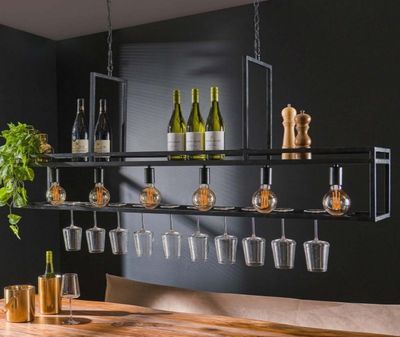 a wooden table with wine glasses and bottles on it