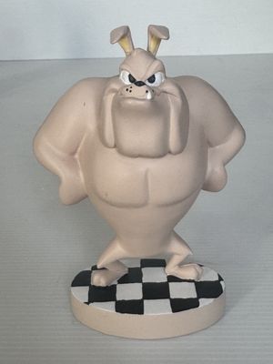 une figurine représentant un personnage de dessin animé posée sur une surface à carreaux
