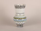 a white vase with a blue and green design on it