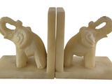 pair of elephant bookends on marble base on white background