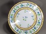 two plates and a bowl on display on a table