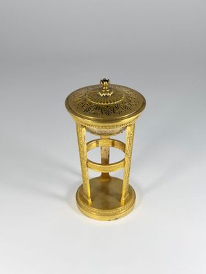 an old brass table with a clock on top of it