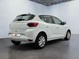 the rear end of a white car in a white room