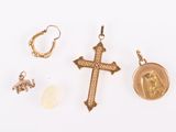 several gold jewelry items including a cross, a coin, and a ring