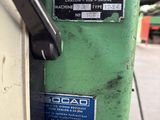 a green machine that has a sign on it