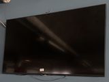 a flat screen tv hanging on a wall in a room