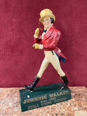figurine of a man in a red jacket and white pants holding a baseball bat