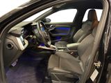the interior of a car with the door open and the driver ' s seat down