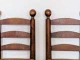 two wooden chairs that are sitting next to each other
