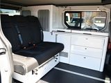 a white van with a black seat and black seat covers