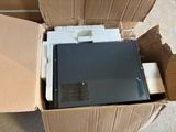 a box with a computer inside of it on the ground