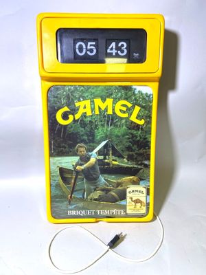 une horloge jaune sur laquelle figure l'image d'un homme pagayant dans un canoë