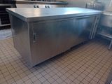 a large stainless steel kitchen island in the middle of a kitchen