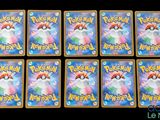 a close up of a group of pokemon cards on a table