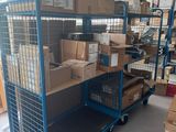 a blue cart with boxes on it in a warehouse
